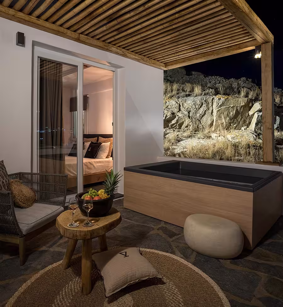 Shaded villa terrace with lounge seating at dusk