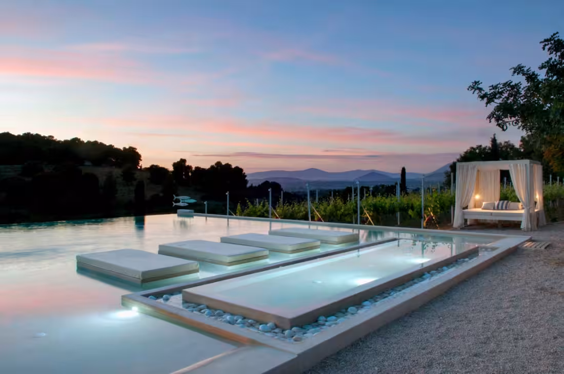Infinity pool at sunset with daybeds